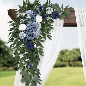 Navy and dusty blue arch flowers and drape fabric.